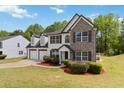 Beautiful two-story home with stone accents, a two-car garage, and professionally landscaped front yard at 3791 Plantation Mill Dr, Buford, GA 30519