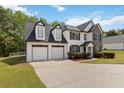 Inviting two-story home with a spacious driveway, two-car garage, and well-maintained landscaping at 3791 Plantation Mill Dr, Buford, GA 30519