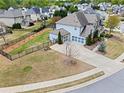 Aerial view of the property showing a fenced backyard, three-car garage, and well-maintained lawn at 331 Spotted Ridge Cir, Woodstock, GA 30188