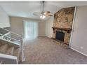 Inviting living room boasting a striking stone fireplace and sliding glass doors for natural light at 6301 Creekford Dr, Lithonia, GA 30058