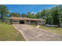 Well-maintained front yard with a long driveway leading to a brick house and garage at 1048 Tumblewood Trl, Lawrenceville, GA 30044
