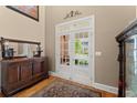 Bright entryway featuring hardwood floors, decorative rug, and glass french doors leading to an outdoor area at 12150 Dancliff Trce, Alpharetta, GA 30009
