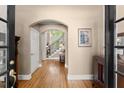 Elegant foyer with hardwood floors, an arched doorway, and a staircase leading to the upper level at 12150 Dancliff Trce, Alpharetta, GA 30009