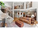 Spacious living room with high ceilings, hardwood floors, and a staircase leading to the upper level at 12150 Dancliff Trce, Alpharetta, GA 30009