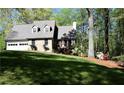 Beautiful exterior showcasing the home's design, a manicured lawn, and mature trees at 1521 Larkwood Dr, Canton, GA 30114