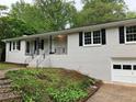 White brick house with dark shutters and attached garage at 1871 Kinridge Rd, Marietta, GA 30062