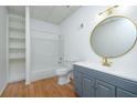 Bright bathroom featuring a shower-tub combo, modern vanity and wood grain floors at 20 Marietta St # 4B, Atlanta, GA 30303