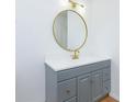 Modern bathroom featuring a round mirror, white countertop, and gray vanity at 20 Marietta St # 4B, Atlanta, GA 30303
