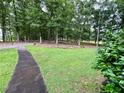 Lush green lawn and trees line the driveway leading to a beautiful home at 527 Gaddis Rd, Canton, GA 30115