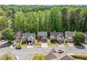 Aerial view of homes in the neighborhood surrounded by mature trees and blue skies at 610 Durham Ridge Nw Dr, Lilburn, GA 30047
