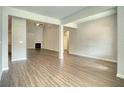 Spacious living room featuring wood flooring, fireplace, and ample natural light at 911 Park Place St, Social Circle, GA 30025