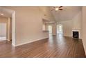 Open concept living room with vaulted ceiling, fireplace and hardwood floors at 911 Park Place St, Social Circle, GA 30025