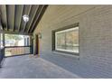 Spacious front porch with modern lighting, brick walls and a seating area at 1705 Ezra Church Nw Dr, Atlanta, GA 30314