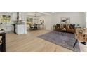 Open-concept living room with hardwood floors, modern furniture, and a seamless flow to the kitchen at 220 Hobnail Se Ct, Marietta, GA 30067