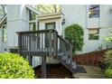 Inviting front entryway with wooden porch and stairs, landscaped yard and stone foundation at 3727 Cline Se Dr, Smyrna, GA 30082