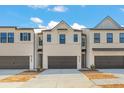 Modern townhome exterior with a gray garage door, and beautiful architectural details at 1026 Sutherland Lane (Lot 44), Lawrenceville, GA 30043