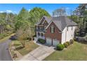 Charming two-story home with a two-car garage, pristine landscaping, and a spacious driveway on a sunny day at 1812 Mountain Lake Nw Dr, Kennesaw, GA 30152