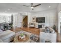Comfortable living room with hardwood floors, ceiling fan, and decorative fireplace at 1923 Prospect Park Ln, Decatur, GA 30033