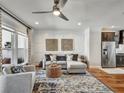 Cozy living area with hardwood floors, neutral color palette, ceiling fan and easy access to the kitchen at 1923 Prospect Park Ln, Decatur, GA 30033