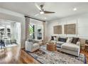 Bright living room with stylish furnishings, decorative wall art, and large windows with view to outdoor space at 1923 Prospect Park Ln, Decatur, GA 30033