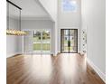 Bright, airy entryway with hardwood floors, high ceilings, and modern chandelier at 584 Indian Hills Pkwy, Marietta, GA 30068