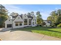 Beautiful white painted home with a three car garage and expansive manicured lawn at 584 Indian Hills Pkwy, Marietta, GA 30068