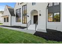 Elegant home with black framed windows, freshly laid black mulch, and brick facade at 584 Indian Hills Pkwy, Marietta, GA 30068