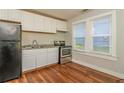 Efficient kitchen with stainless steel appliances, laminate floor and bright natural light at 946 Crew Sw St, Atlanta, GA 30315