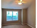 Bedroom featuring neutral walls, carpet, a ceiling fan, and a window with privacy blinds at 1975 Hoods Fort Nw Cir # 24, Kennesaw, GA 30144