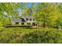 Charming two-story traditional home featuring black shutters and a lush front yard at 3040 Greenfield Dr, Marietta, GA 30068