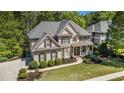 Traditional home with a lush front lawn and a covered porch, perfect for relaxing at 629 Gold Valley Pass, Canton, GA 30114