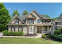 Inviting home featuring a stone-accented porch and beautifully maintained landscaping at 629 Gold Valley Pass, Canton, GA 30114