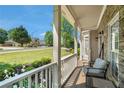 Charming front porch view with seating and stone accents and manicured lawn at 629 Gold Valley Pass, Canton, GA 30114