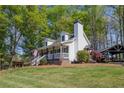 Beautiful home featuring a welcoming front porch and lush landscaping, set on a sprawling green lawn at 8132 Union Hill Rd, Canton, GA 30115
