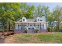 Inviting home with a spacious front porch, perfect for relaxing and enjoying the outdoor scenery at 8132 Union Hill Rd, Canton, GA 30115