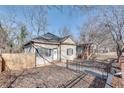 View of a single-story home featuring a fenced yard, landscaping, and charming curb appeal at 1415 Eric Se St, Atlanta, GA 30315