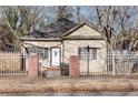 Charming single-story home featuring a fenced yard, mature trees, and welcoming front entrance at 1415 Eric Se St, Atlanta, GA 30315