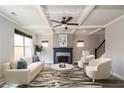 Staged living room featuring coffered ceiling, modern furnishings, fireplace and ample natural light at 2331 Bouldercliff Se Way, Atlanta, GA 30316