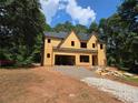 Exterior view of a two-story house under construction with a gravel driveway and surrounding trees at 3920 Bellair Dr, Marietta, GA 30066
