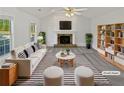 Bright living room featuring a fireplace, vaulted ceilings, and large windows at 823 New Hope Rd, Mcdonough, GA 30252