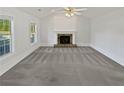 Bright living room featuring a fireplace, vaulted ceilings, and large windows at 823 New Hope Rd, Mcdonough, GA 30252