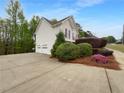 Home featuring an attached two-car garage and a driveway with ample parking at 131 Diamond Ct, Carrollton, GA 30116