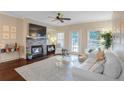 Cozy living room features a stone fireplace with mounted TV and lots of natural light at 211 Colonial Homes Nw Dr # 2106, Atlanta, GA 30309