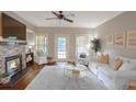 Inviting living room with stone fireplace, large windows, and comfortable seating area at 211 Colonial Homes Nw Dr # 2106, Atlanta, GA 30309