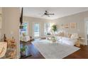 Bright living room with hardwood floors, plush seating, and views of the outdoor area at 211 Colonial Homes Nw Dr # 2106, Atlanta, GA 30309