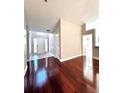Inviting foyer with hardwood floors leading to a brightly lit front door at 2608 Cascade Cove Dr, Buford, GA 30519