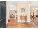 Inviting foyer with hardwood floors, a decorative table, and a view into the living room at 4034 Brockett Walk, Tucker, GA 30084