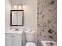 Bathroom featuring a tiled shower, white vanity, and modern fixtures at 1679 Hollyhock Ter, Decatur, GA 30032