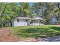 Charming one-story home with a well-manicured front yard on a sunny day at 1679 Hollyhock Ter, Decatur, GA 30032