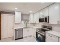 Updated kitchen boasting stainless steel appliances, white cabinetry, and sleek countertops at 1679 Hollyhock Ter, Decatur, GA 30032